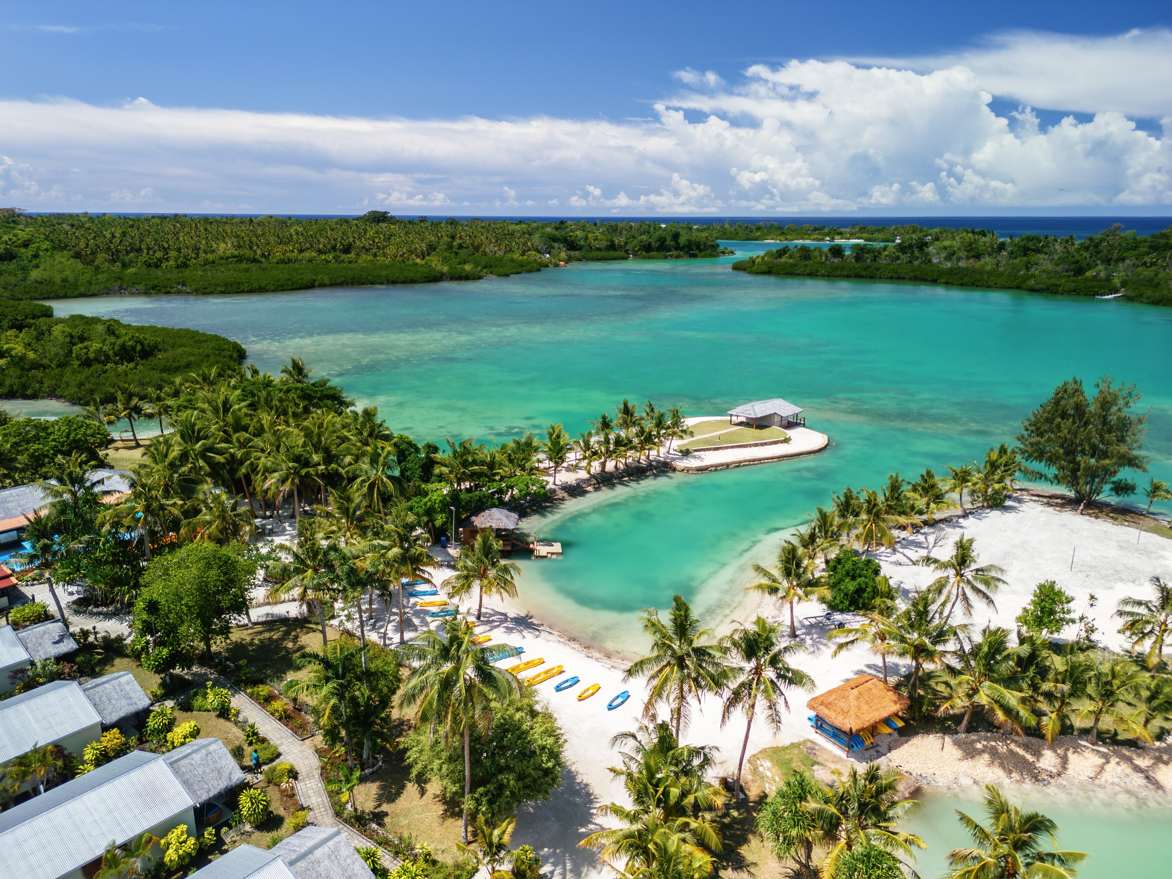 E'Nauwi Beach Resort aerial view β stunning turquoise lagoon with white sand beach and palm trees on Malekula Island