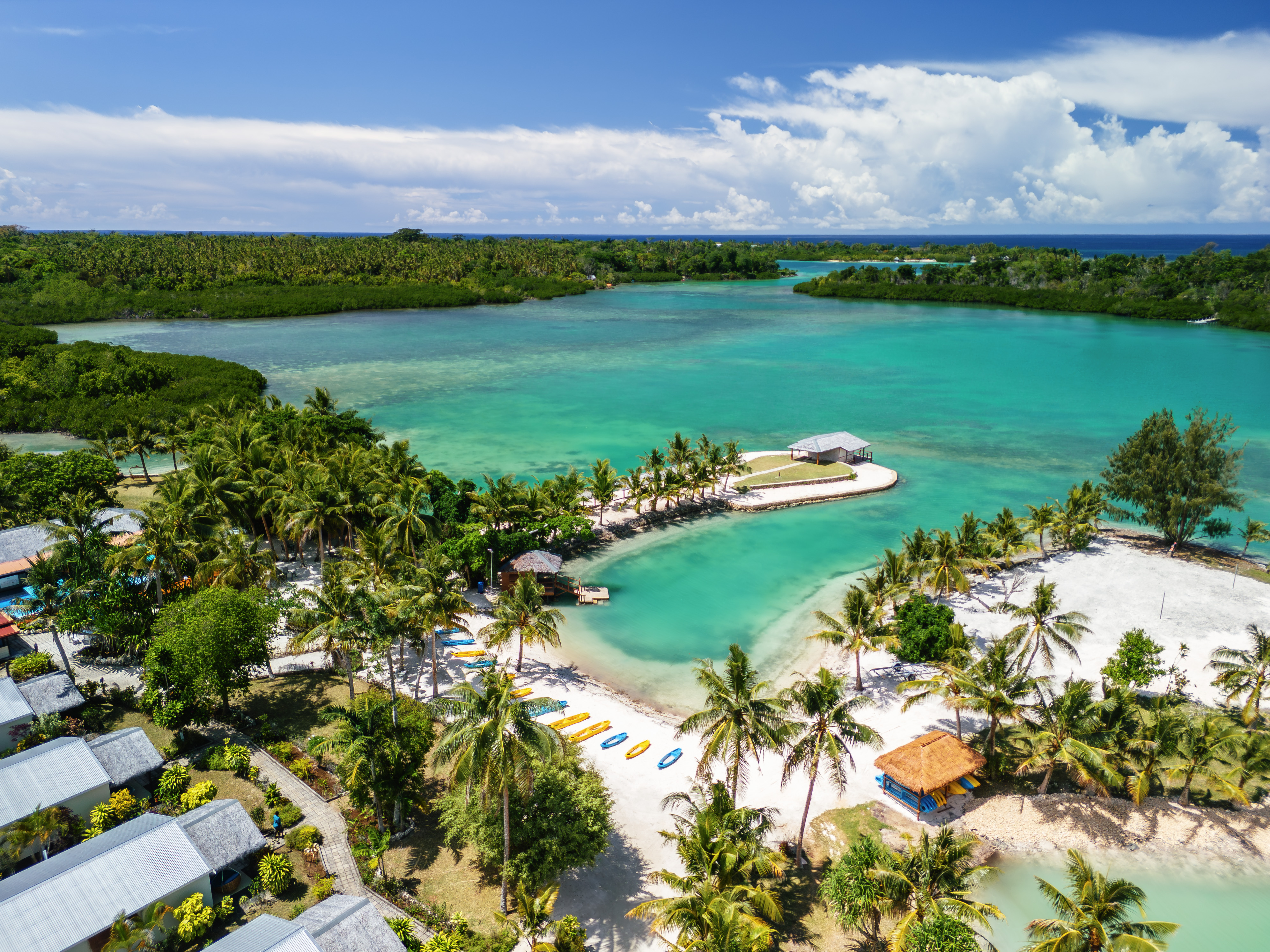 E'Nauwi Beach Resort aerial view β stunning turquoise lagoon with white sand beach and palm trees on Malekula Island